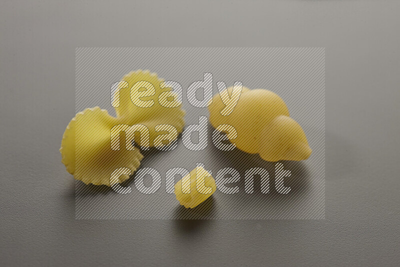 Different pasta types on grey background