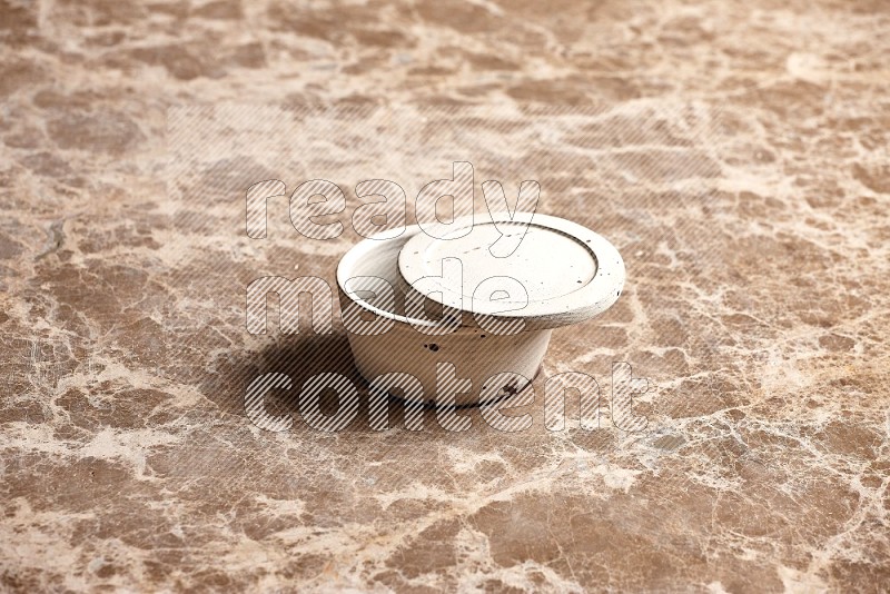 White Pottery Bowl on Beige Marble Flooring, 45 degrees