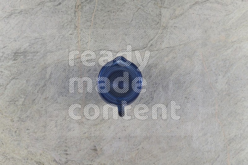 Top View Shot Of An Empty Glass Jug On Grey Marble Flooring