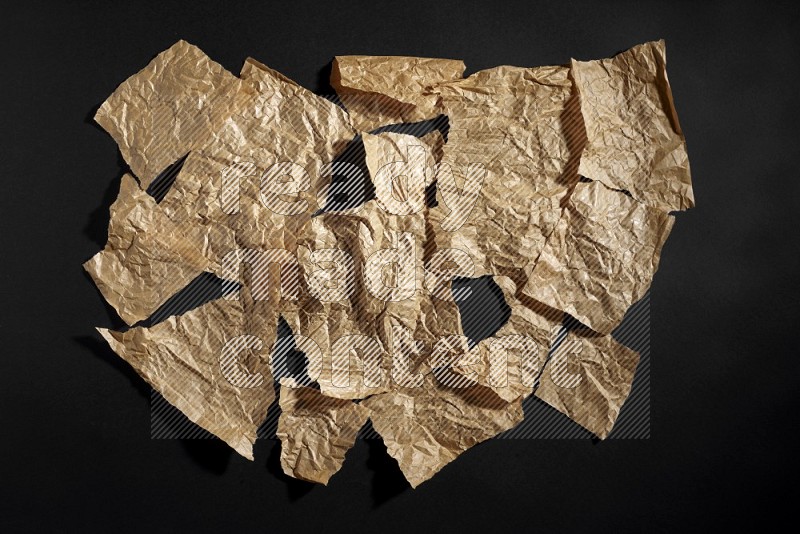 Crumpled craft paper on black background