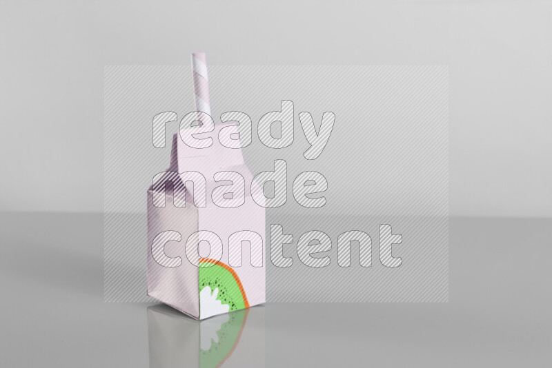 Origami juice box on grey background