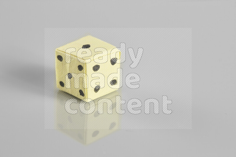 Origami dice on grey background