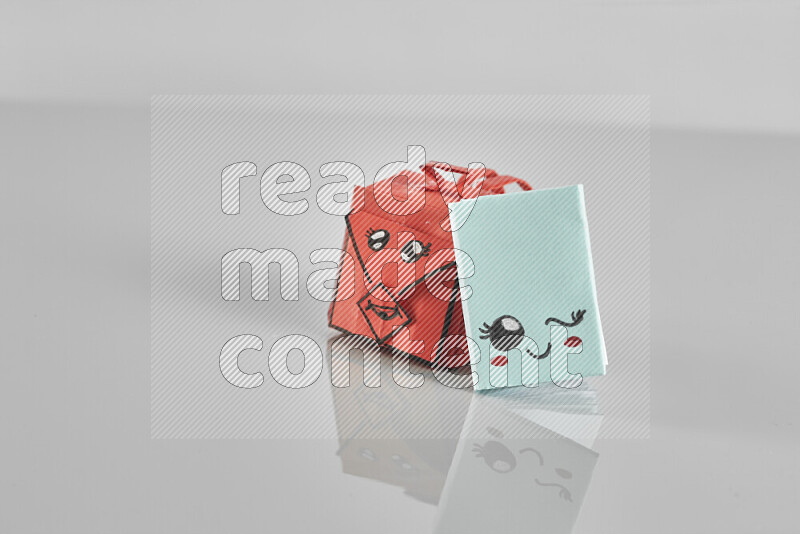 Origami school supplies such as back bag, books and ruler on grey background