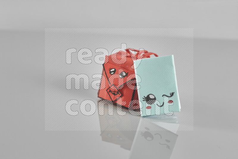 Origami school supplies such as back bag, books and ruler on grey background