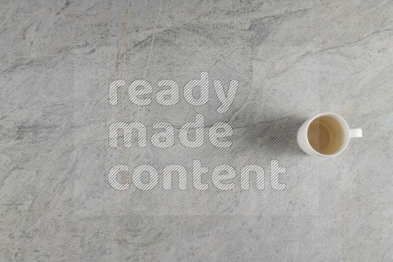 A multicolored pottery Cup on grey marble background