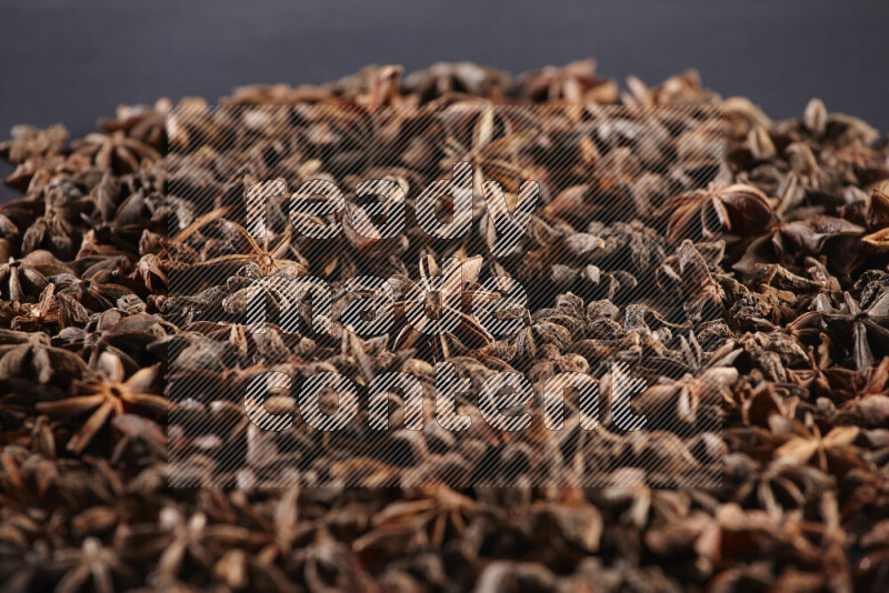 Star Anise fill the frame on black flooring