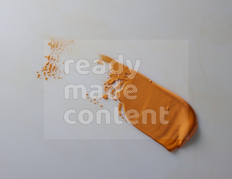 An orange straight painting knife stroke on white background