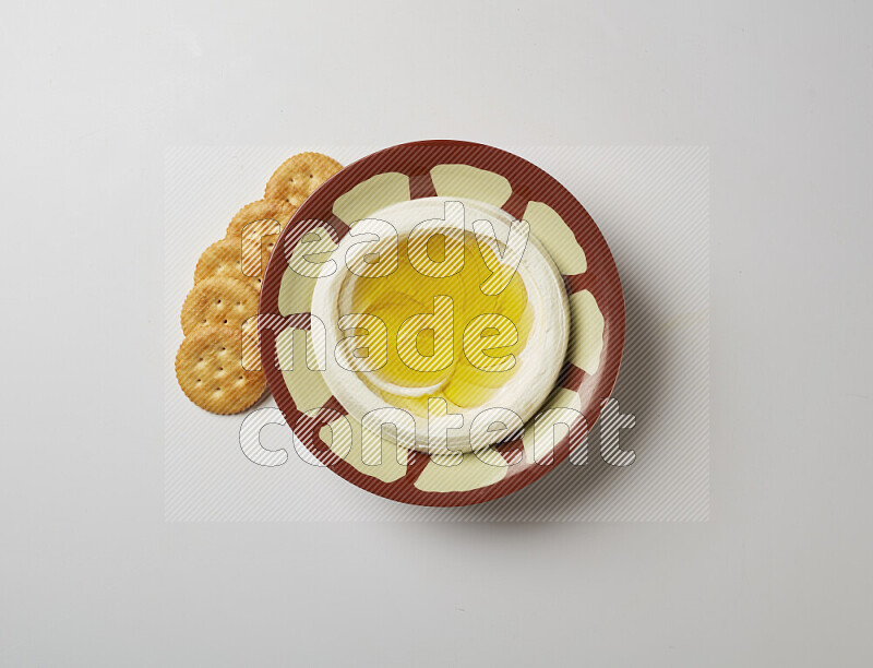 Lebnah garnished with olive oil in a traditional plate on a white background