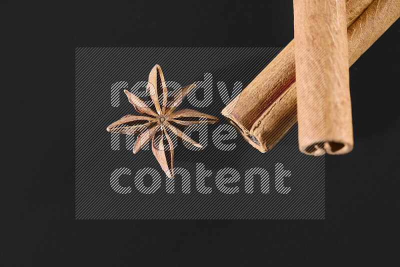 Cinnamon sticks and star anise on black background