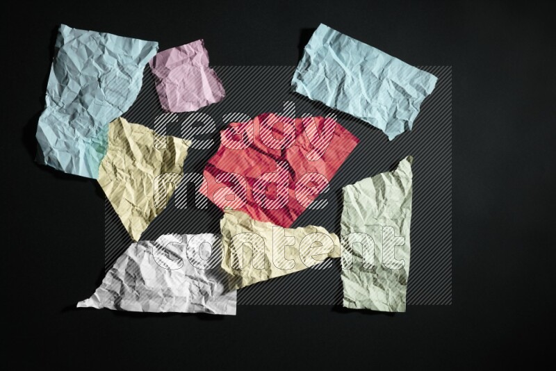 Crumpled multicolored paper on black background