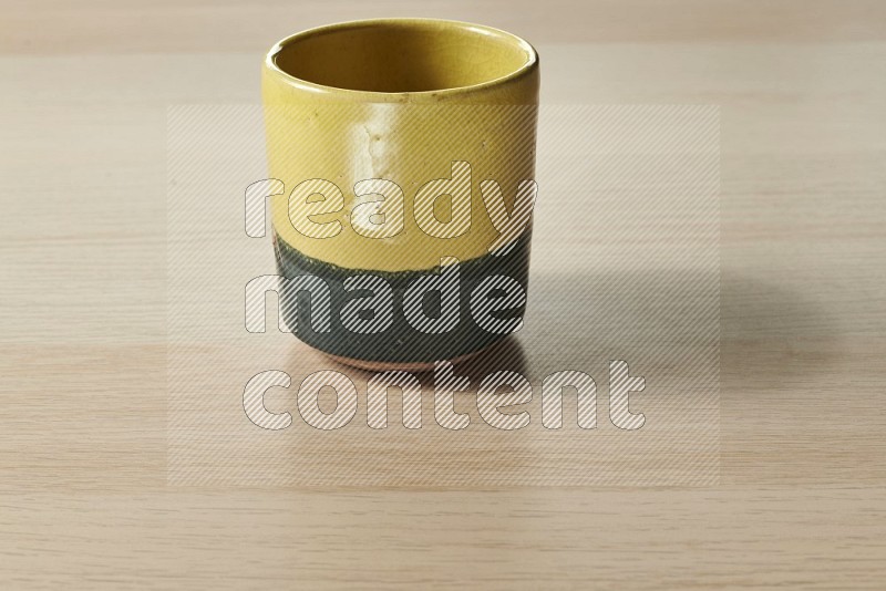 Multicolored Pottery Cup on Oak Wooden Flooring, 15 degrees