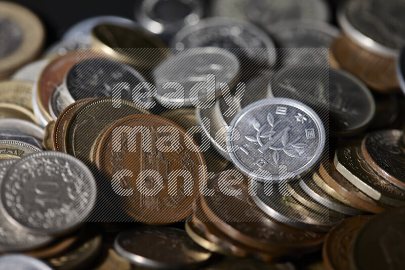A close-ups of random old coins on black background