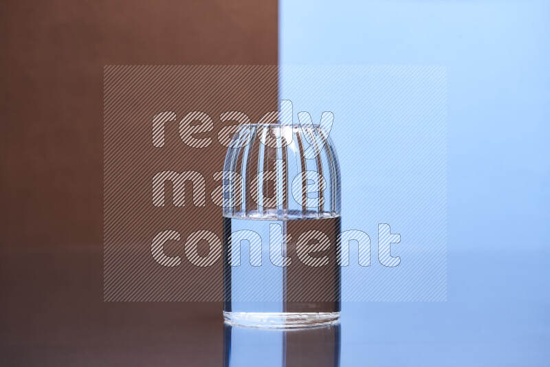 The image features a clear glassware filled with water, set against brown and light blue background