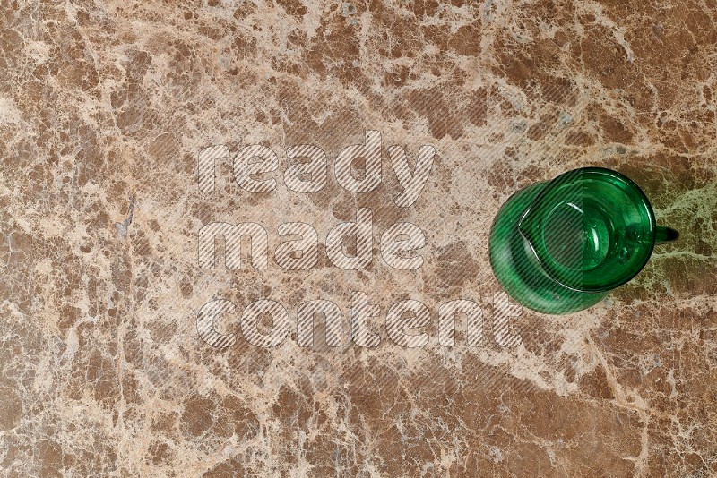 Top View Shot Of An Empty Glass Jug On beige Marble Flooring
