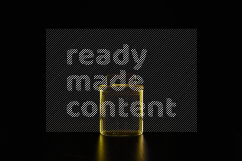 Glassware with rim light in yellow against black background