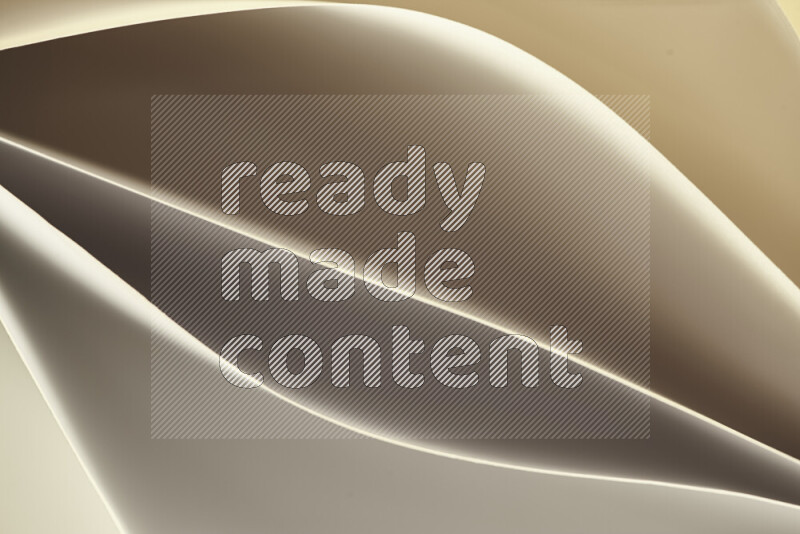 This image showcases an abstract paper art composition with paper curves in gold gradients created by colored light