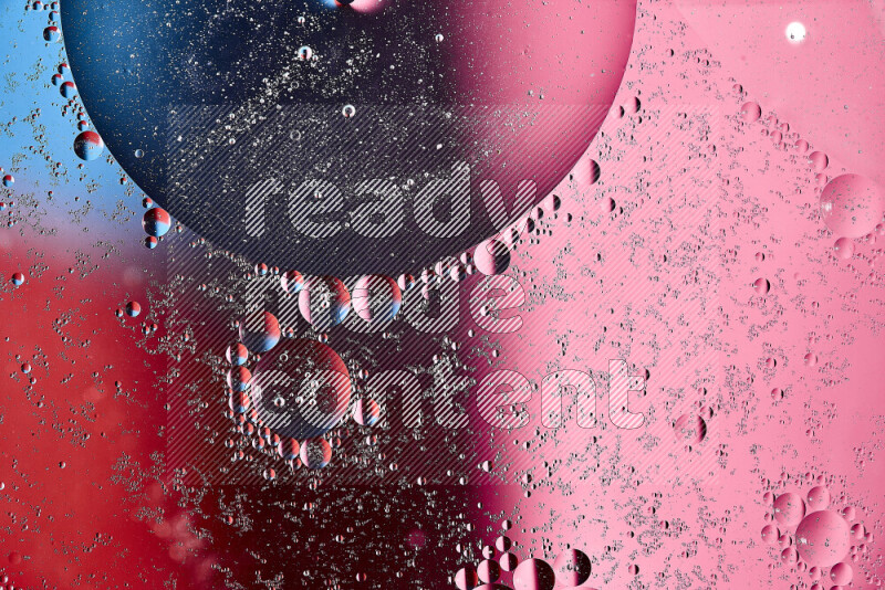 Close-ups of abstract oil bubbles on water surface in shades of blue, red and pink