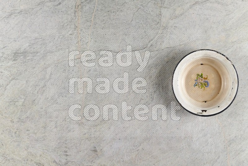 Top View Shot Of A Vintage Metal Plate On Grey Marble Flooring