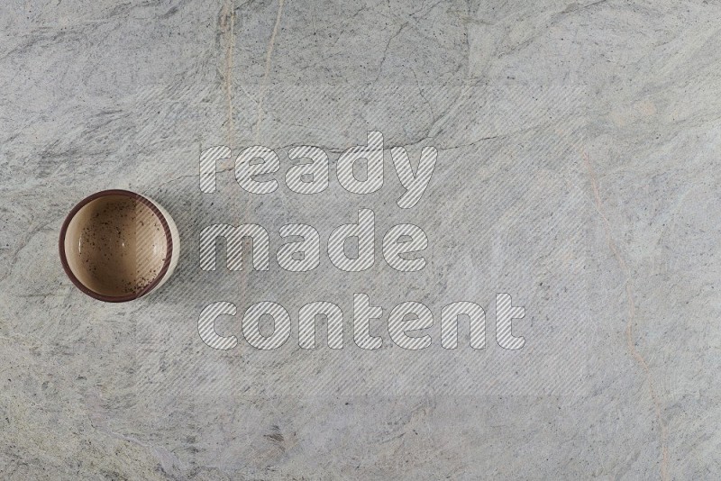 Top View Shot Of A Multicolored Pottery Bowl On Grey Marble Flooring