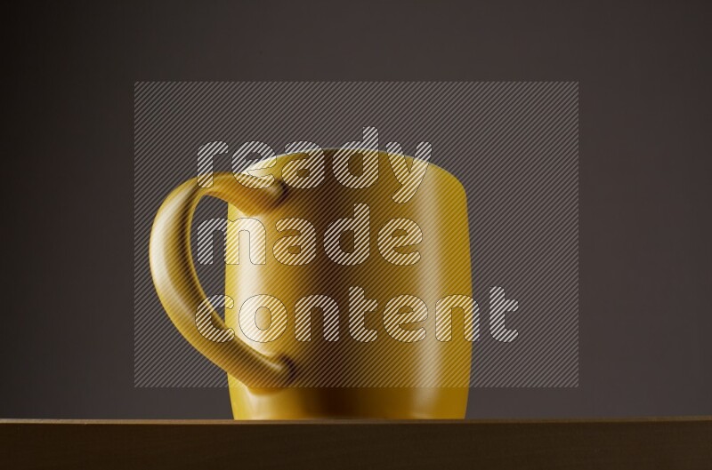 Low angle shot of a yellow cup on grey background