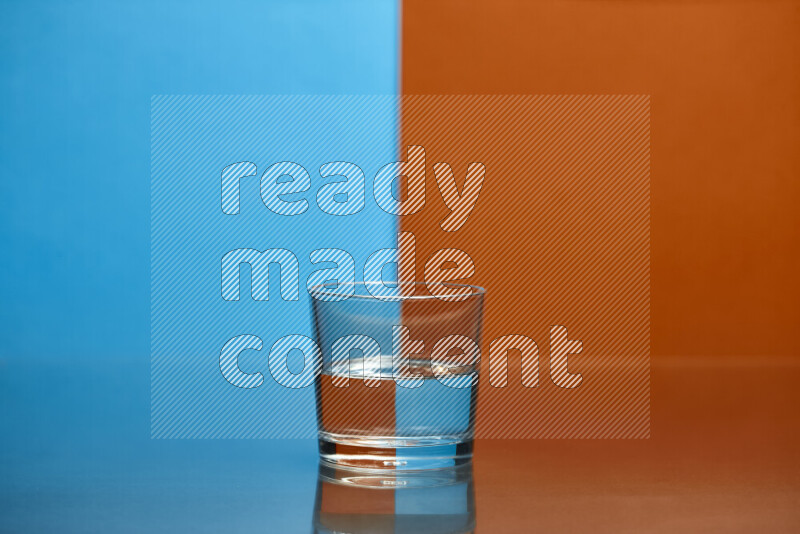 The image features a clear glassware filled with water, set against blue and dark orange background