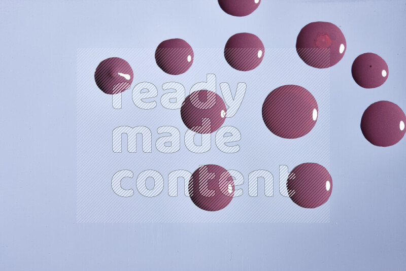 Close-ups of abstract purple paint droplets on the surface