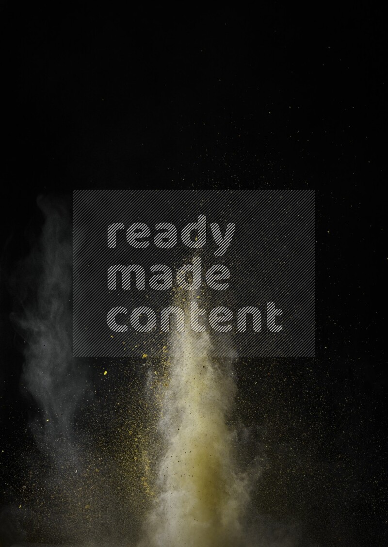 A side view of yellow powder explosion on black background