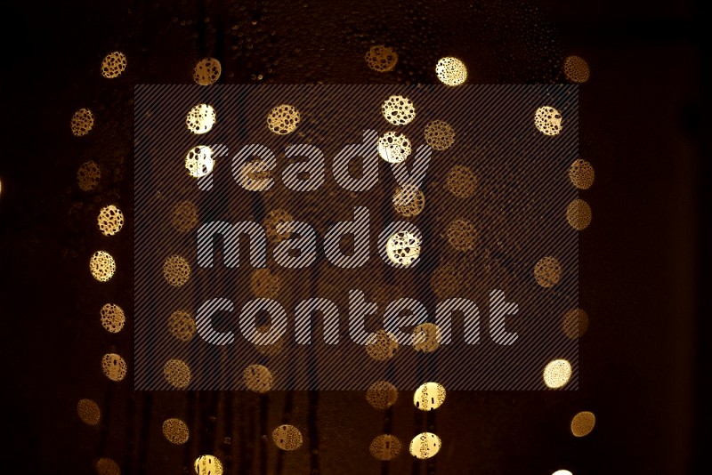 Bokeh light in yellow with water drops