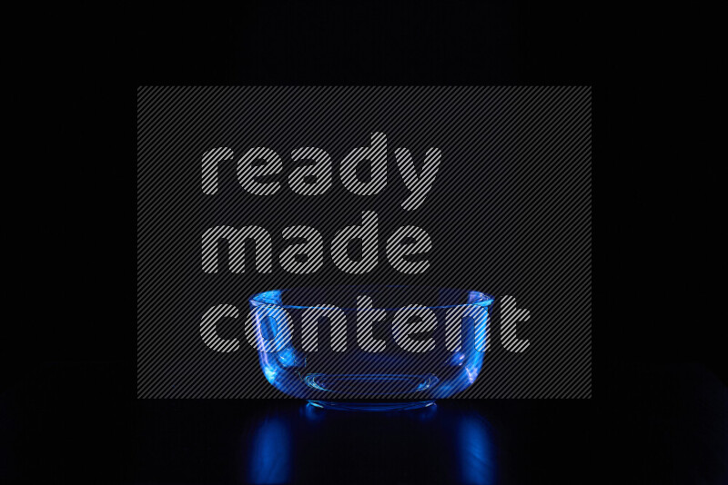 Glassware with rim light in blue against black background