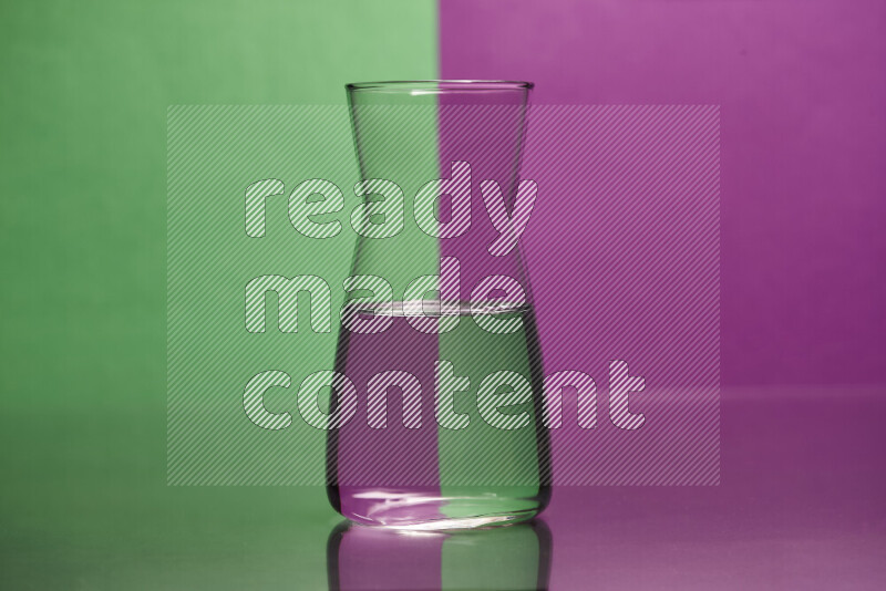 The image features a clear glassware filled with water, set against green and purple background