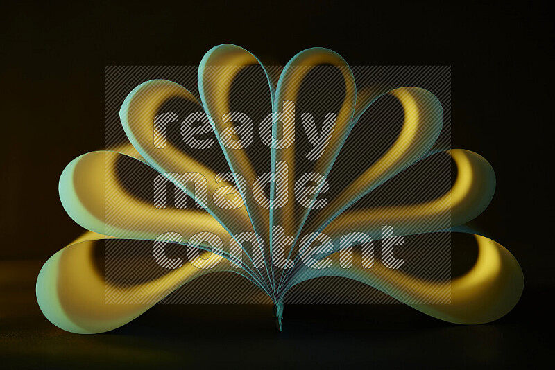 An abstract art piece displaying smooth curves in yellow and green gradients created by colored light