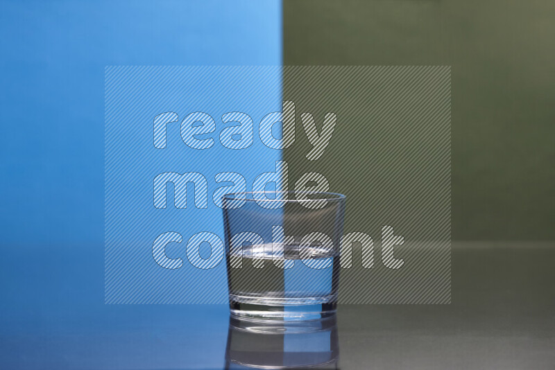 The image features a clear glassware filled with water, set against blue and dark green background