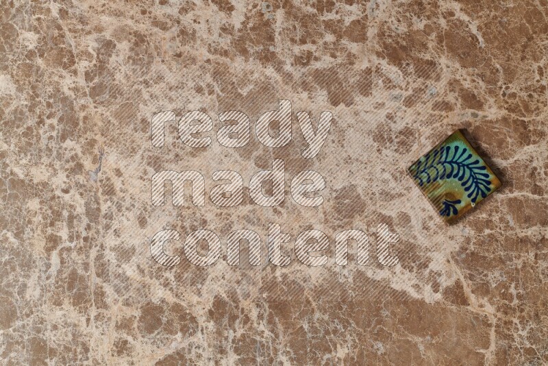 A decorative coaster on beige marble background