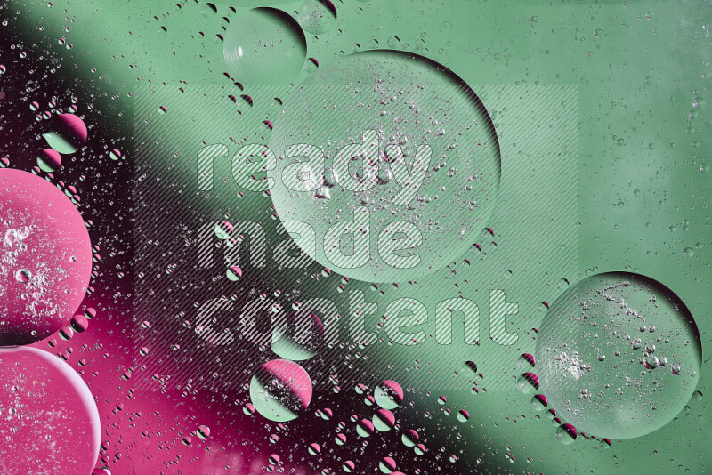 Close-ups of abstract oil bubbles on water surface in shades of green and pink