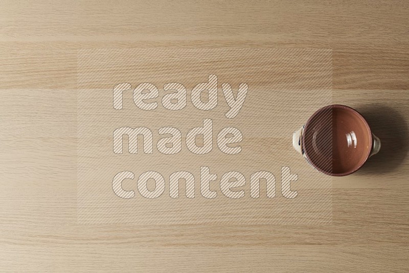 Top View Shot Of A Multicolored Pottery Pot on Oak Wooden Flooring