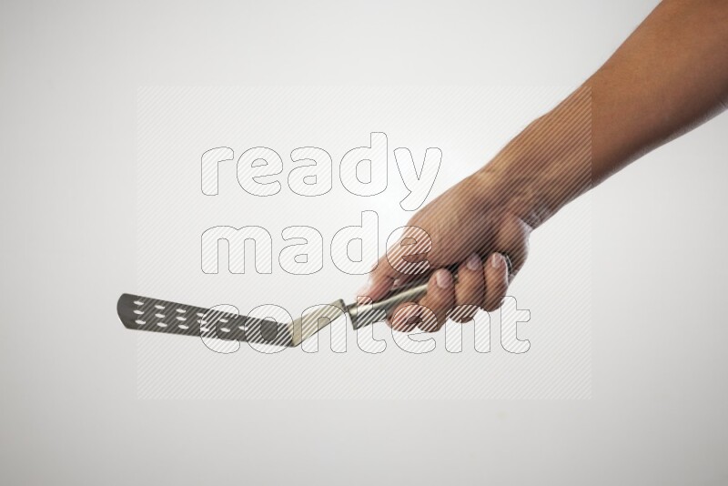 Male Hand Holding Burger Flipper on white background