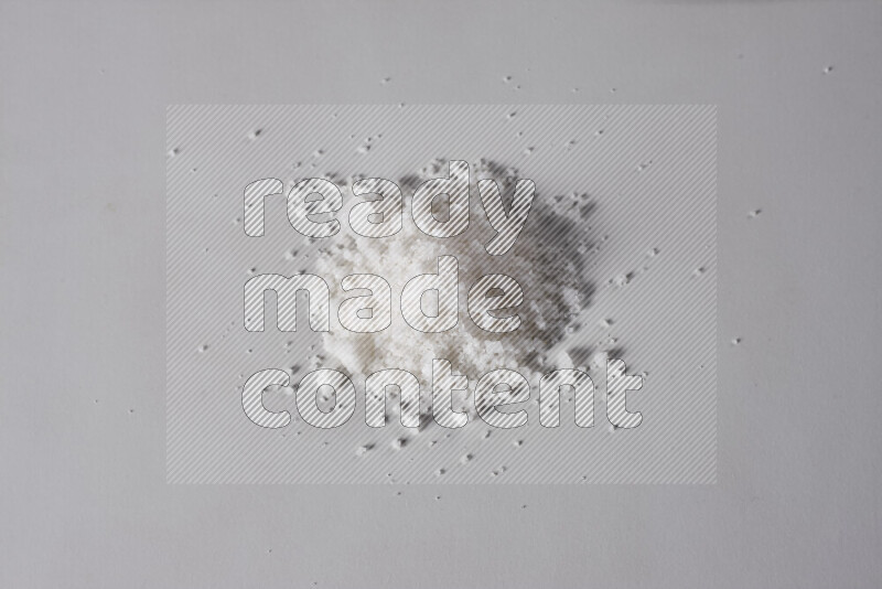 A bunch of coarse sea salt crystals on white background