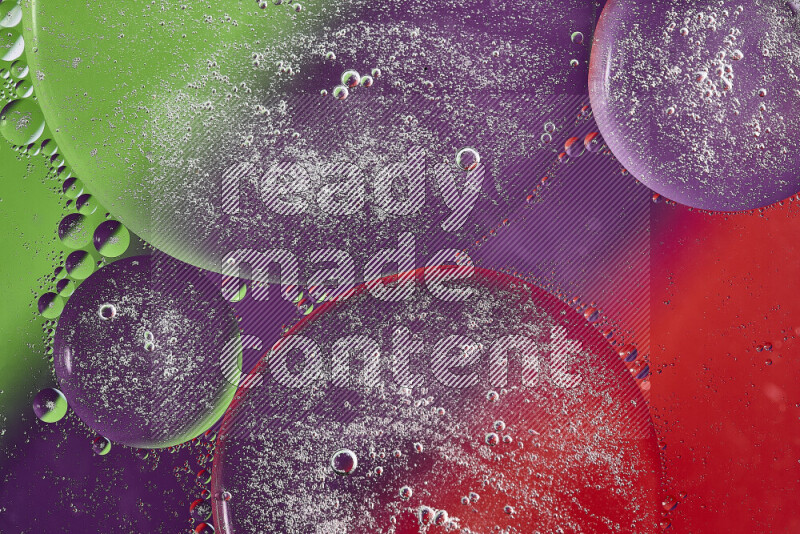 Close-ups of abstract oil bubbles on water surface in shades of purple, green and red