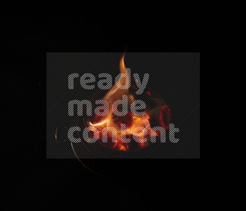 Coal cubes on fire in metal pan