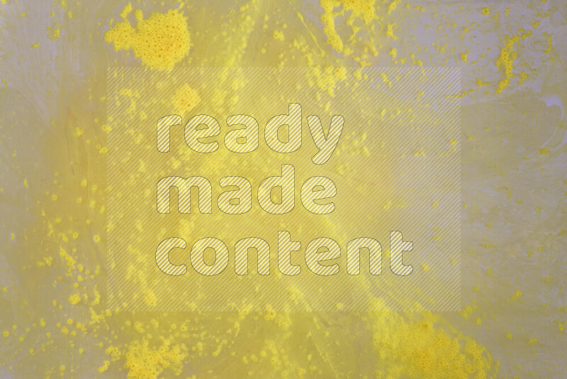 The image captures a dramatic splatter of yellow paint over a white backdrop