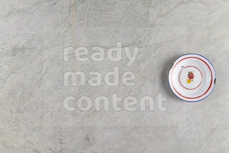 A vintage metal plate on grey marble background