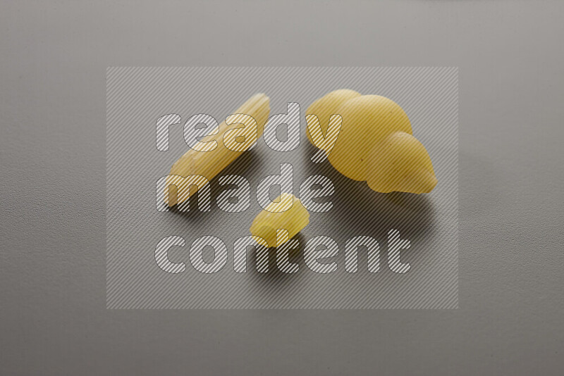 Different pasta types on grey background