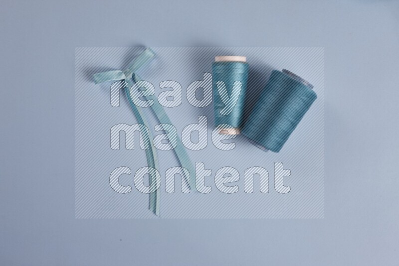 A blue collection of sewing and tailoring tools arranged on a blue background