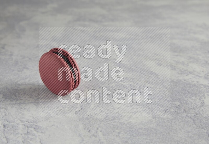 45º Shot of Red Cherry macaron on white  marble background