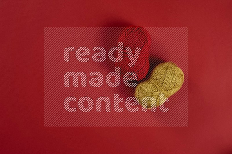 Yellow sewing supplies on red background