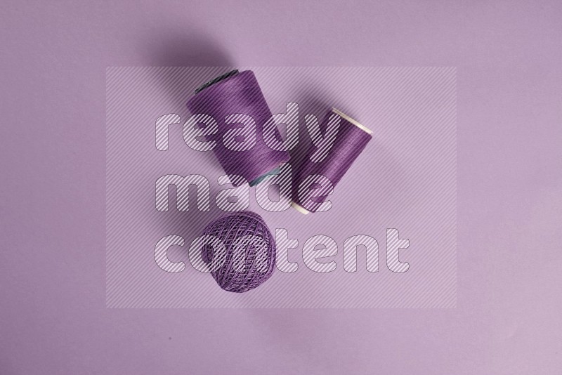 Purple sewing supplies on purple background