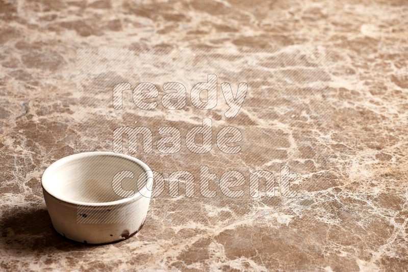 White Pottery Bowl on Beige Marble Flooring, 45 degrees