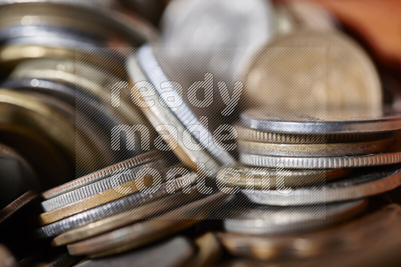 A close-ups of random old coins on black background