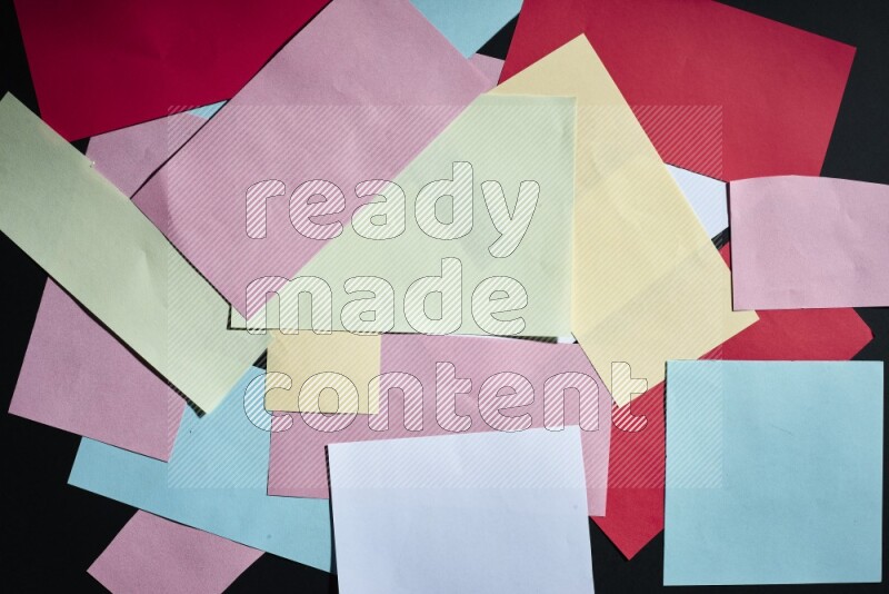 Multicolored paper sheet on black background