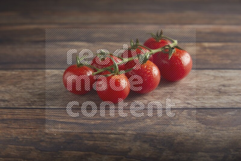 Red cherry tomato vein on a textured wooden background 45 degree